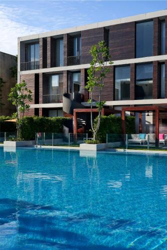 a large swimming pool in front of a building at SO/ Sofitel Hua Hin in Cha Am