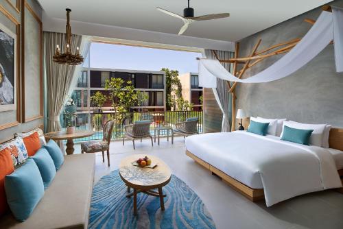 a bedroom with a bed and a living room at SO/ Sofitel Hua Hin in Cha Am