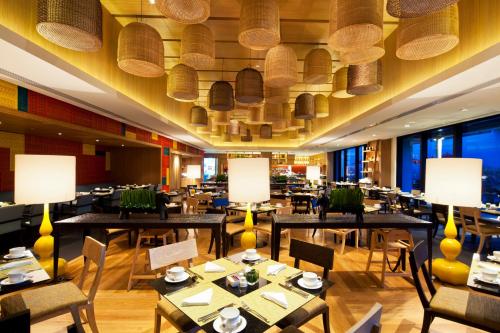 a dining room with tables and chairs and ceilings at Amari Hua Hin in Hua Hin