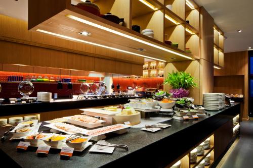 a buffet line in a restaurant with food on display at Amari Hua Hin in Hua Hin