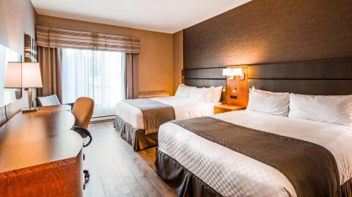 En eller flere senge i et værelse på Best Western Premier Hotel Aristocrate