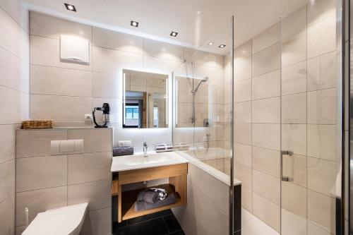 a bathroom with a sink and a mirror at Biwak Appartements in Sankt Anton am Arlberg