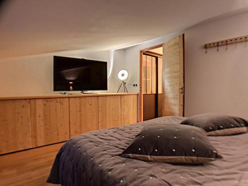 - une chambre avec un lit et une télévision à écran plat dans l'établissement La Durance, à Montgenèvre