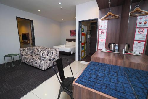 a room with a room with a bed and a couch at S Boutique Hotel in Ipoh