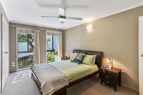 a bedroom with a bed and a window at Noosa Rest in Noosa Heads