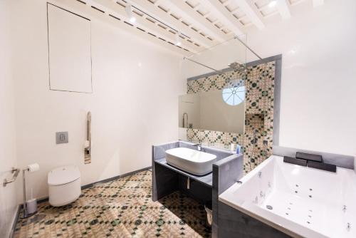 a bathroom with a sink and a toilet at La Casa del Consul in C&aacute;diz
