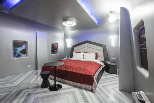 a bedroom with a bed and a table in it at Motel Stars in Taichung
