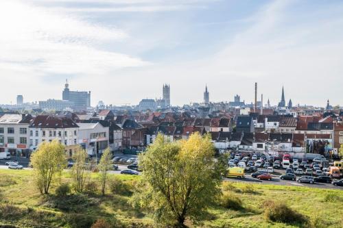 a cityscape of a city with cars on a highway at Skyline Flats Gent in Ghent