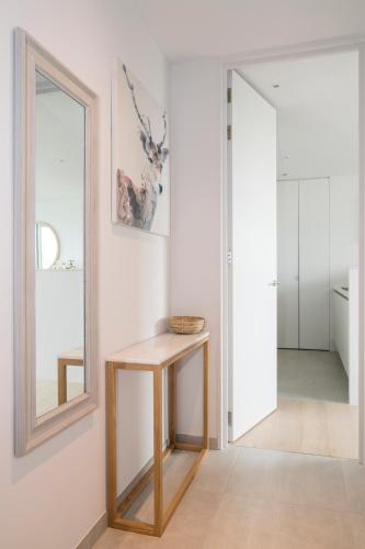 a dressing room with a table and a mirror at Skyline Flats Gent in Ghent