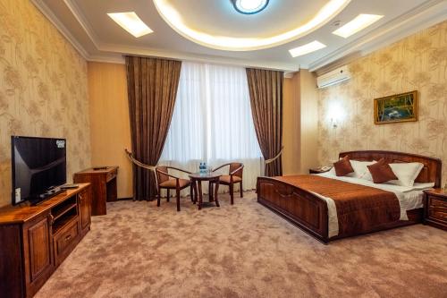 A bed or beds in a room at Meros Boutique Hotel