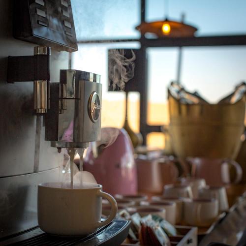 a coffee maker is making coffee in a cup at The Desert Grace in Solitaire