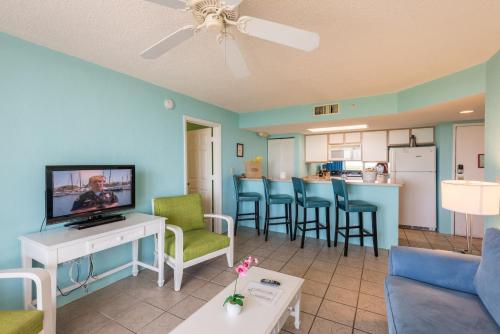 a living room with a couch and a tv at Sunrise Suites Bonaire Suite #210 in Key West