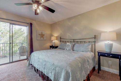 a bedroom with a bed and a ceiling fan at Gulf Winds #39 in Destin