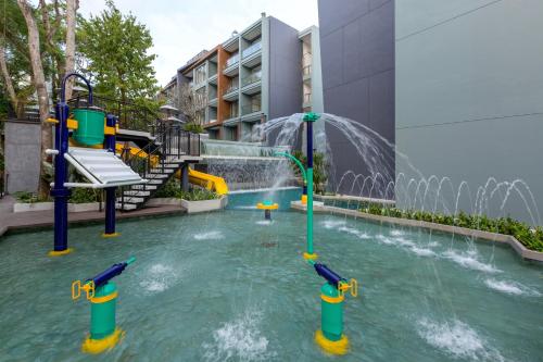 a pool with a water park with a water slide at The Nature Phuket - SHA Extra Plus in Patong Beach