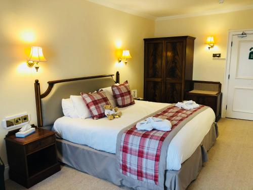 
A bed or beds in a room at Dryburgh Abbey Hotel
