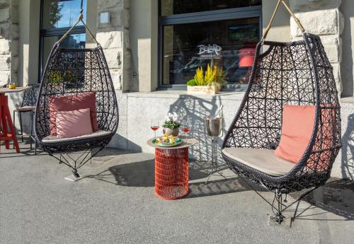 two chairs with pillows sitting on a patio at Cascada Boutique Hotel in Luzern