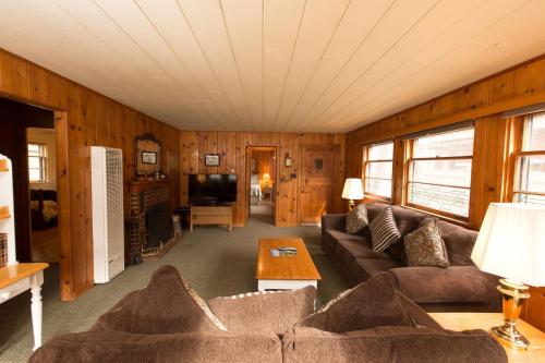 a living room with a couch and a tv at Mirror Pond in Bend