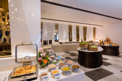 a buffet line with food on display in a restaurant at The Nature Phuket - SHA Extra Plus in Patong Beach