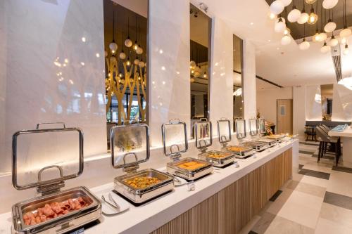 a buffet line with many trays of food at The Nature Phuket - SHA Extra Plus in Patong Beach