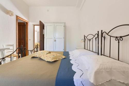 Katil atau katil-katil dalam bilik di Trullo Dei Messapi