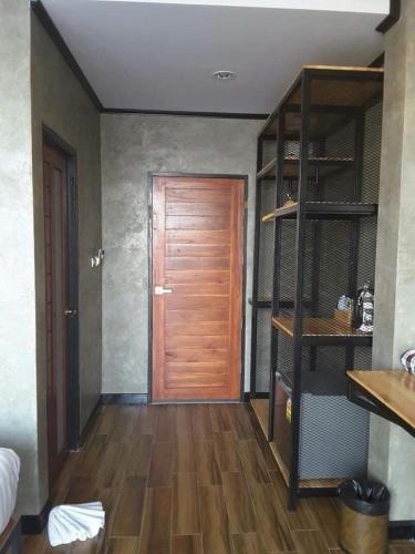 a room with a wooden door and a wooden floor at Lanta Chaolay in Ko Lanta
