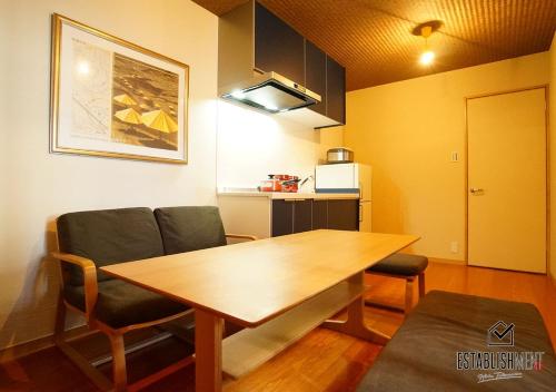 a dining room with a wooden table and chairs at BEYOND HOTEL Takayama 1st in Takayama