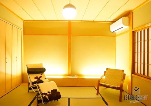 a room with two chairs and a heater and a lamp at BEYOND HOTEL Takayama 1st in Takayama