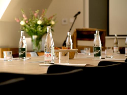 a table with three empty bottles on top of it at Le Manoir des Impressionnistes - Bord de Mer in Honfleur