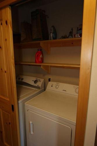 a small kitchen with a washing machine in a closet at Hutson's Hideaway 30 Day in Hood River