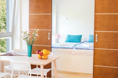 a dining room with a table and a window at Apartamenty Bałtycka by Renters in Świnoujście