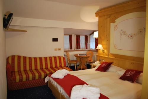 Una cama o camas en una habitación de Piccolo Hotel
