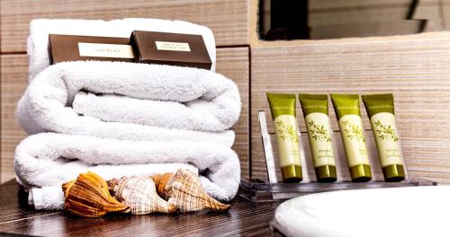 a pile of towels on a counter in a bathroom at Astir Notos in Potos