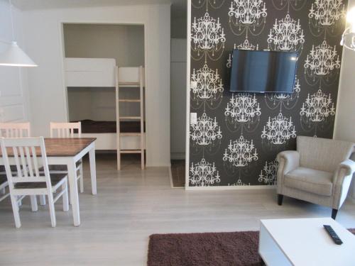 a living room and dining room with a table and chairs at Rantahiekka B3 in Kalajoki