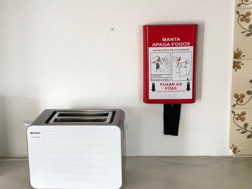 a wall with a sign next to a stove at Fatima Belavista & Pool in Fátima