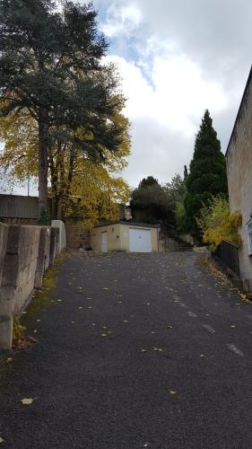 a driveway with a white garage and a tree at Dorian House Boutique B&B - Free Parking! in Bath