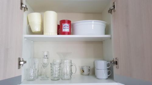 a cupboard with jars and other kitchen items in it at Excelente Apartamento Alto Padrão Centro Ed Dubai in Capão da Canoa