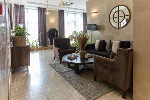 a living room with a couch and a table at Garden Hotel in Bishkek