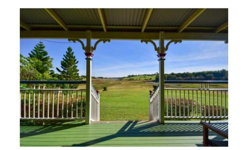 a porch with a view of a field of grass at Lakefront holiday villa in Yungaburra