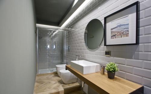 a bathroom with a white sink and a mirror at Stylish apartment in the center of Naples by Wonderful Italy in Naples
