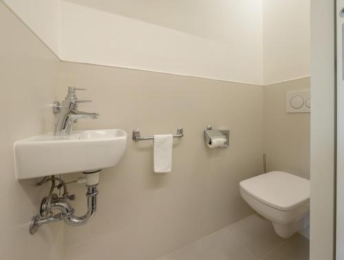 a bathroom with a sink and a toilet at Hotel Continental in Brno