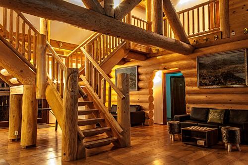 a wooden house with a staircase in a living room at Welcome Lambafell in Eyvindarhólar