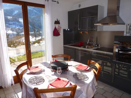 a kitchen with a table with a white table cloth on it at PLEIN SOLEIL appartement avec GARAGE pour SKI TROIS VALLEES et CURE THERMALE in Brides-les-Bains