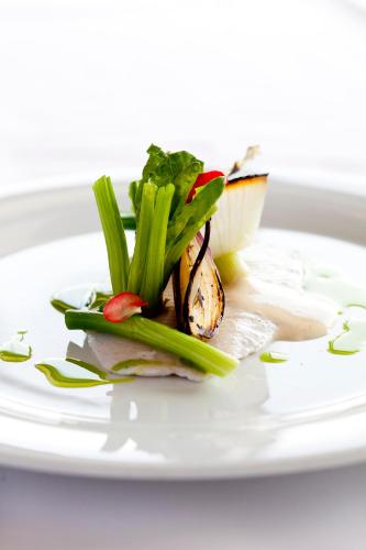 a white plate with a dish with food on it at Glostrup Park Hotel in Glostrup