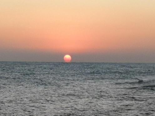 a sunset over the ocean with the sun in the horizon at Appartamento La Rondine in Pesaro
