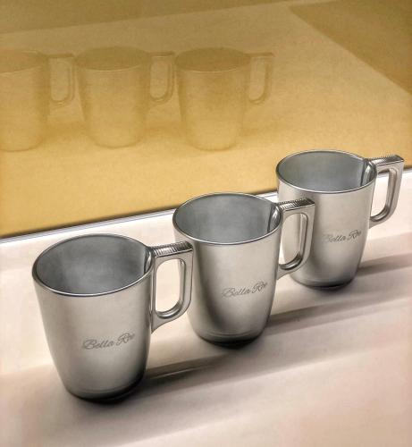 a group of three coffee cups sitting on a shelf at Bella Roe Premium Apartments in Belgrade