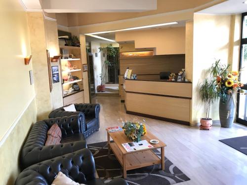 a living room with couches and a coffee table at Hotel San Luca in Rossano