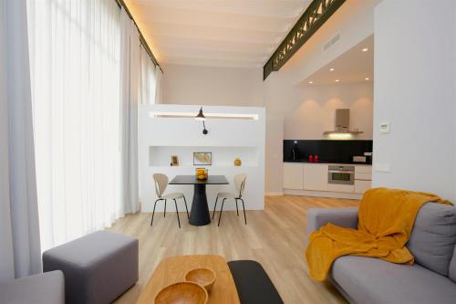a living room with a couch and a table at L´Aguila Suites - Turismo de Interior in Palma de Mallorca