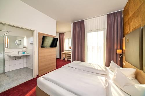Postel nebo postele na pokoji v ubytování Hotel am Stadtrand