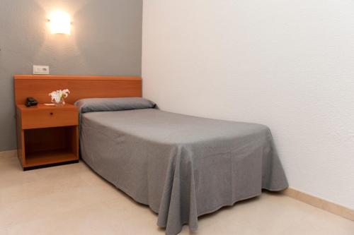 Ένα ή περισσότερα κρεβάτια σε δωμάτιο στο Hotel El Palmeral