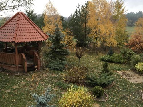 a gazebo in a garden with trees at Ignacówka in Kobyla Góra